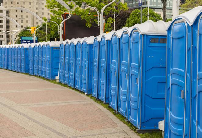 a line of portable restrooms set up for a wedding or special event, ensuring guests have access to comfortable and clean facilities throughout the duration of the celebration in Natick